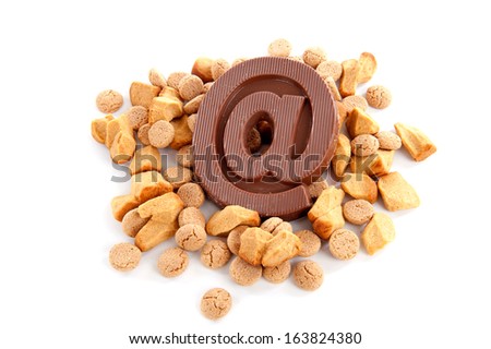 a atpersand, made of chocolate with a lot of ginger-nuts on a white background