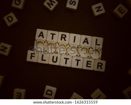 Atrial Flutter, word cube with background.