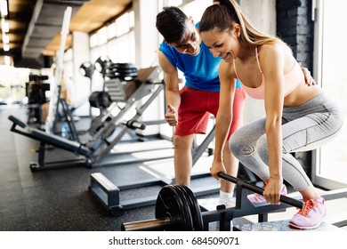 Atrractive woman doing exercises for back muscles in gym - Powered by Shutterstock