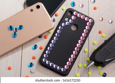 Attaching Colorful Rhinestones Onto Phone Cases With A Glue Gun. Artsy DIY Project, Decor For Mobile Accessories.