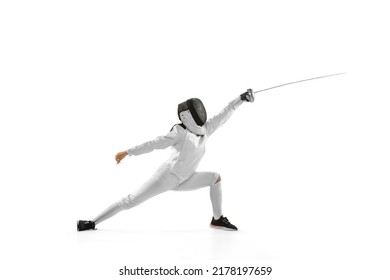 Attack. Young girl, beginner fencer in fencing costume and mask practicing with rapier isolated on white background. Sport, youth, healthy lifestyle, achievements. Copy space for ad - Powered by Shutterstock