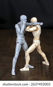 Attacker: Throws a right punch to the face. Defender: Steps left outside the attack line, deflects with right arm, and strikes the ribs with the left elbow.