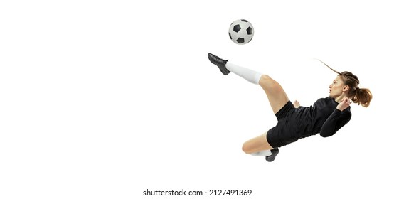 Attacking player. One sportive girl, female soccer player training with football ball isolated on white studio background. Concept of sport, fitness. Young sportive girl in motion. Copy space for ad