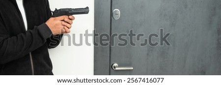 Attempted murder, man prepares to attack from the doorway with a gun in his hand
