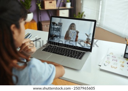 Attending Online Learning Session with Tutor on Laptop