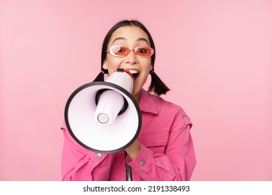 Attention, Announcement Concept. Enthusiastic Asian Girl Shouting In Megaphone, Advertising With Speaker, Recruiting, Standing Over Pink Background