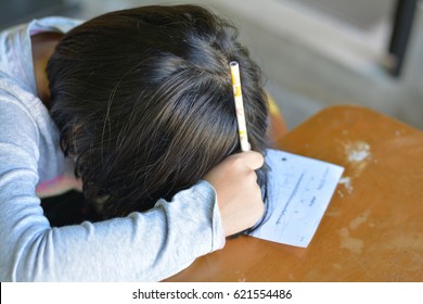 Attention Deficit Hyperactivity Disorder (ADHD) And Learning Disability (LD) In Children And Teens Concept.Female Cute Child Asleep On Paper.Asian Students Sleeping While Practice Math Subject At Home