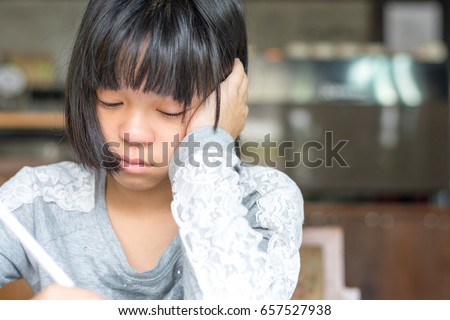 Attention deficit hyperactivity disorder (ADHD) and Learning disability (LD) in education children and teens concept. Asian kid student girl doing examination homework from school with stress. 