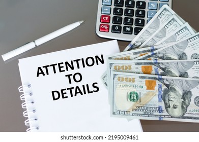 Attention To Detail Text On A Notepad On A Table Next To A Calculator And Dollar Bills