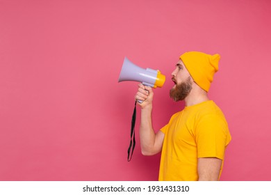 Attention! European man shouting in megaphone on pink background - Shutterstock ID 1931431310