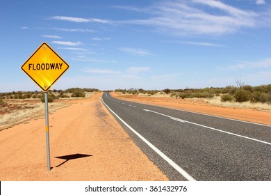 Attention, Floodway Safety Sign (flood Way) At Desert Road, Outback Australia. Weather Conditions Can Change Suddenly, So There Will Be Danger Of Rising Flood Waters By Extreme Rainfall.