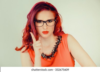 Attention, listen to me. Close up portrait of young woman wagging her finger isolated green wall background. Negative human emotions face expression, life perception, feelings, body language, attitude