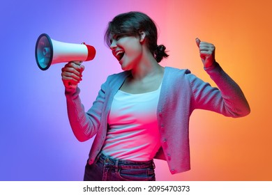 Attention, news. Excited young beautiful girl in warm cardigan shouting at megaphone isolated on gradient blue orange neon background. Concept of emotions, facial expression, youth, aspiration, sales - Shutterstock ID 2095470373