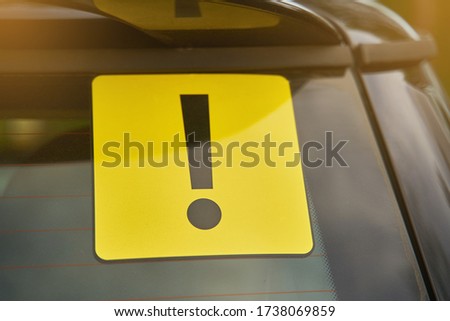 Attention sign on car glass. Inexperienced driver concept.