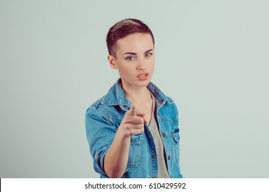 Attention, you listen to me. Close up portrait of young woman wagging her finger isolated green wall background. Negative human emotions face expression life perception feelings body language attitude