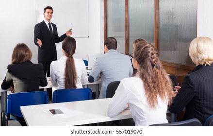 Attentive Business Students With Teacher In Classroom
