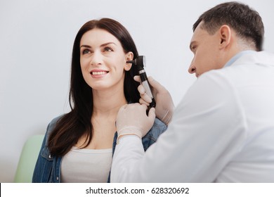 Attentive Doctor Doing Ear Exam Of Pretty Woman