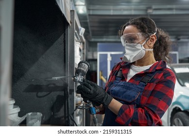 Attentive Female Mechanic Using Spray Compressor For Work