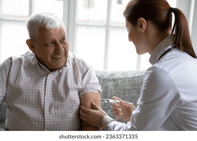 Attentive female nurse make arm injection to positive senior 80s male patient in hospital, caring woman doctor vaccinate smiling mature 70s man in clinic, vaccination, elderly healthcare concept - Powered by Shutterstock