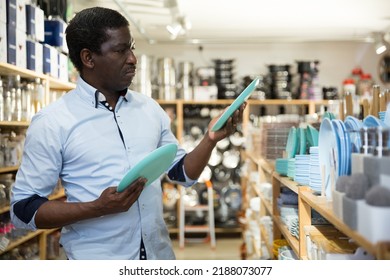 Attentive Man Choosing New Crockery In Dinnerware Store