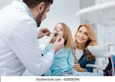 Attentive mom brining her child to the dentist - Powered by Shutterstock