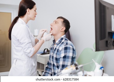 Attentive Otolaryngologist Doing Throat Exam