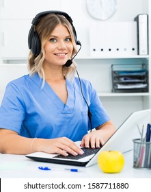 Attentive Specialist Of Medical Call Center In Headphones In Office