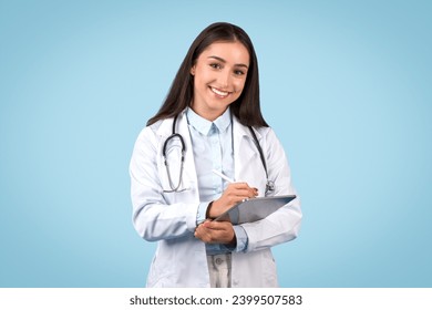 Attentive young female doctor in a white coat using digital tablet, representing thorough patient care and medical documentation, smiling at camera - Powered by Shutterstock