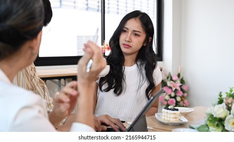 Attentive Young Woman Listening Intently During Discussion Of Business Ideas In Meeting