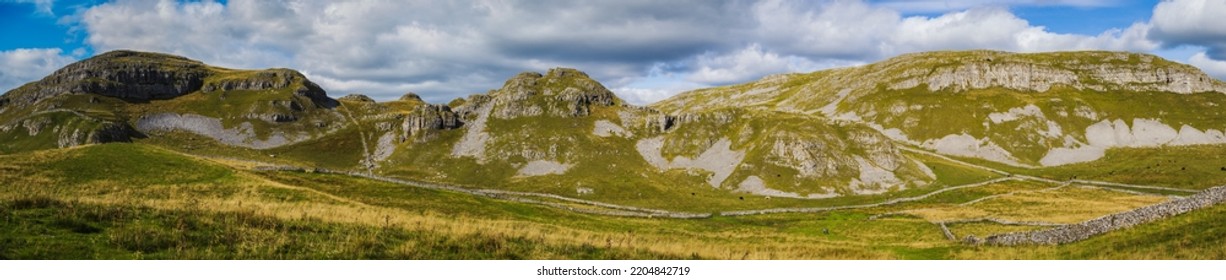 Attermire Scar is the dominant feature along the line of the Mid Craven Fault to the east of Settle, and the scree slopes below once met the waters of ‘Attermere’ itself, a small upland lake. - Shutterstock ID 2204842719