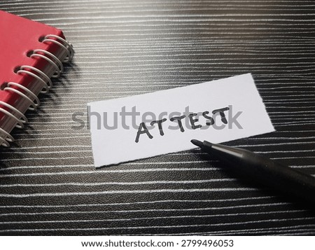 Attest writting on table background. 