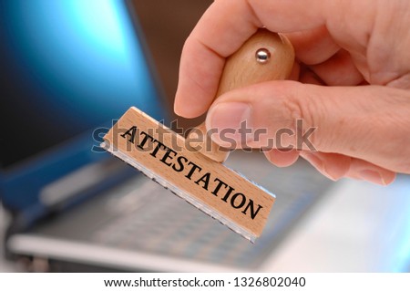 attestation  printed on rubber stamp in hand
