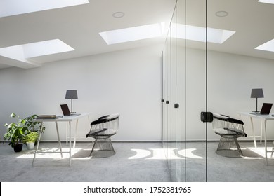 Attic Home Office With White Walls, Simple Desk And Chair And Long, Mirrored Wardrobe