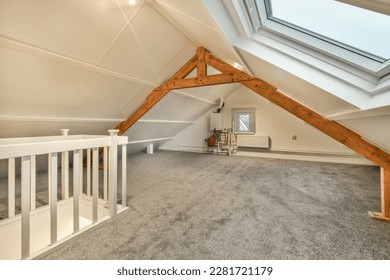 an attic loft with skylights and carpeted flooring in the attic, which has been used as a home office