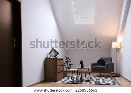 Attic room interior with slanted ceiling and furniture