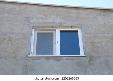 Attic Window Of An Unpainted Old Apartment