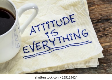 attitude is everything - motivational slogan on a napkin with a cup of coffee