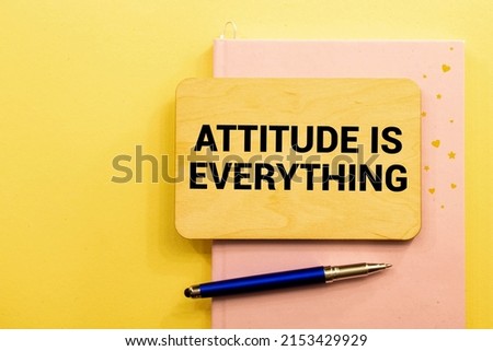Attitude Is Everything text torn from boxes of paper.