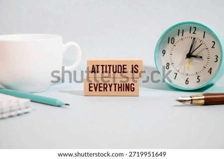 Attitude Is Everything text torn from boxes of paper.