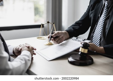 Attorney Gives The Client A Pen To Sign A Contract Admitting Fraud, Lawyer Admits A Fraud Case In Which Client Is A Victim And Will Sue Defendant Who Is A Commercial Partner. Fraud Litigation Concept.