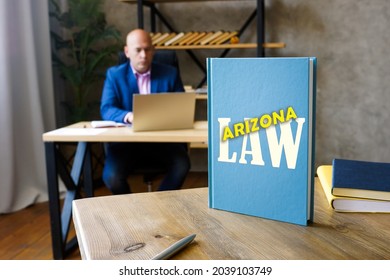 Attorney Holds ARIZONA LAW Book. Arizona Residents Are Subject To Arizona State And U.S. Federal Laws
