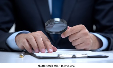 Attorney reading document with magnifier, studying case in detail, investigation - Shutterstock ID 1539656501