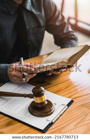 Attorney reading law code, studying constitution to protect human rights closeup, Male lawyer or judge working with Law books, gavel
