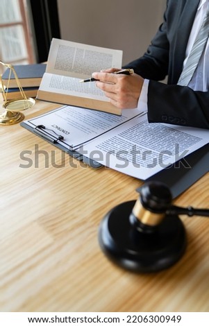 Attorney reading law code, studying constitution to protect human rights closeup, Male lawyer or judge working with Law books, gavel	