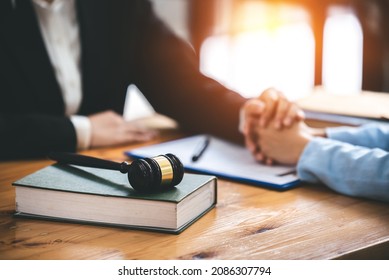 Attorney who provides consolation solutions to his clients. provide legal advice and a serious trusting commitment to issues, justice, and the notion of attorney. - Shutterstock ID 2086307794