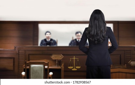 Attorney Woman On Courtroom Talking To Magistrate In Court Box. For Law And Legal Adjustment Concept. The Attorney Communication On Courtroom.