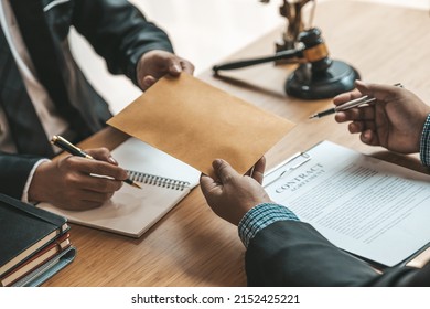 Attorneys are accepting documents from clients who come in to testify in case of embezzlement from business partners who venture into business. The concept of hiring a lawyer for legal proceedings.