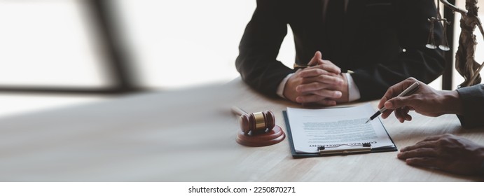 Attorneys or lawyers are advising clients in defamation cases, they are collecting evidence to bring charges against the parties for damages. The concept of defamation case counseling. - Shutterstock ID 2250870271