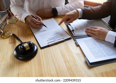 Attorneys or lawyers who are reading the statute of limitations Consultation between male lawyers and business clients, tax and legal and legal services firms.	