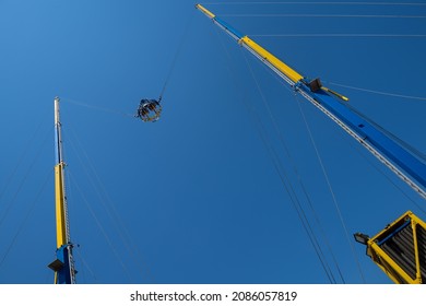 Attraction Catapult or Slingshot against the background of the blue sky